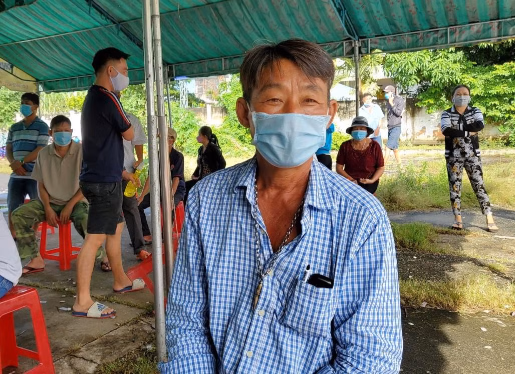 Ông Trần Văn O ngồi chờ lấy phiếu sau khi tiêm. Ảnh: Kim Hà.