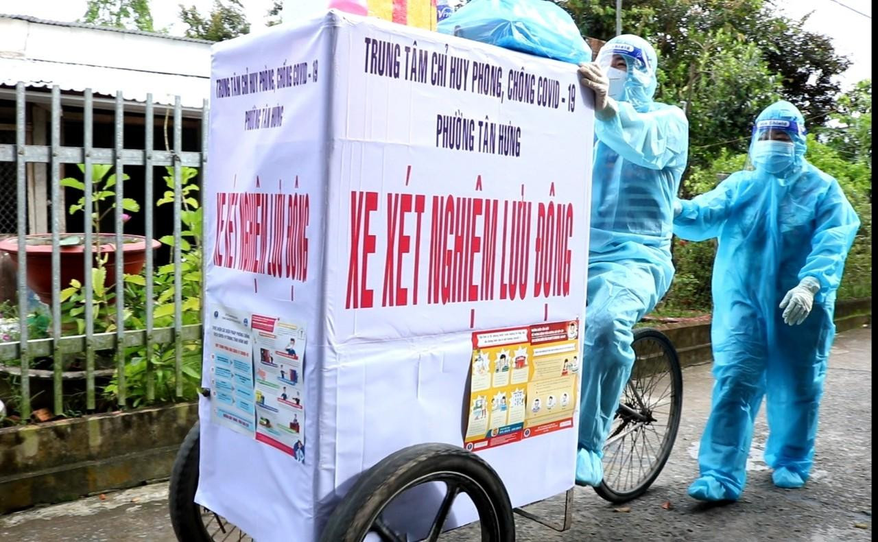 Anh Nguyễn Thanh Hải - Nhân viên Trạm y tế phường Tân Hưng đạp xe "cá viên chiên" đi lấy mẫu xét nghiệm COVID-19 tại nhà dân - Ảnh: Kim Hà.