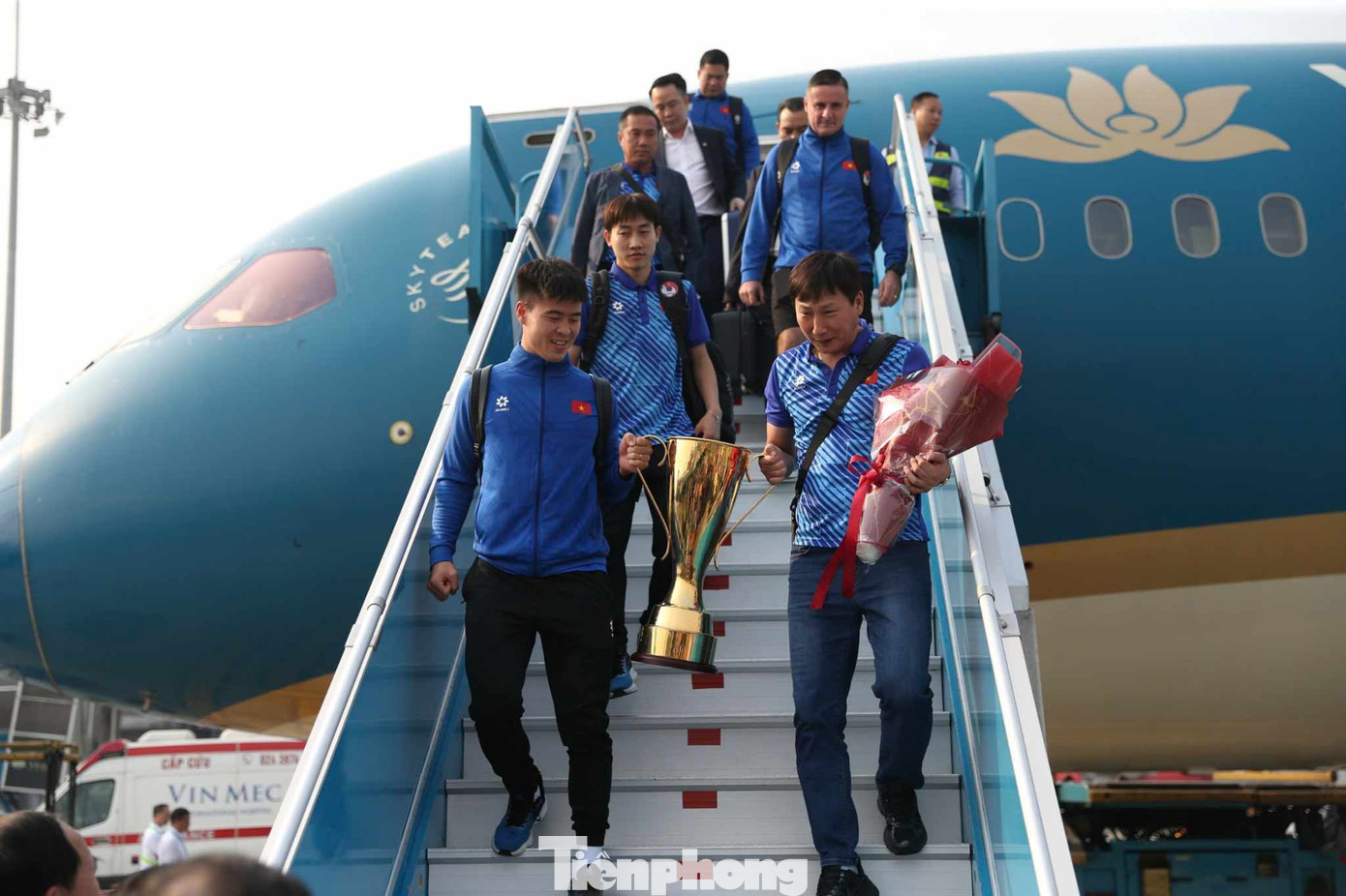 Các cầu thủ tuyển Việt Nam xuống máy bay, cầm theo chiếc cup vô địch trong không khí hân hoan.