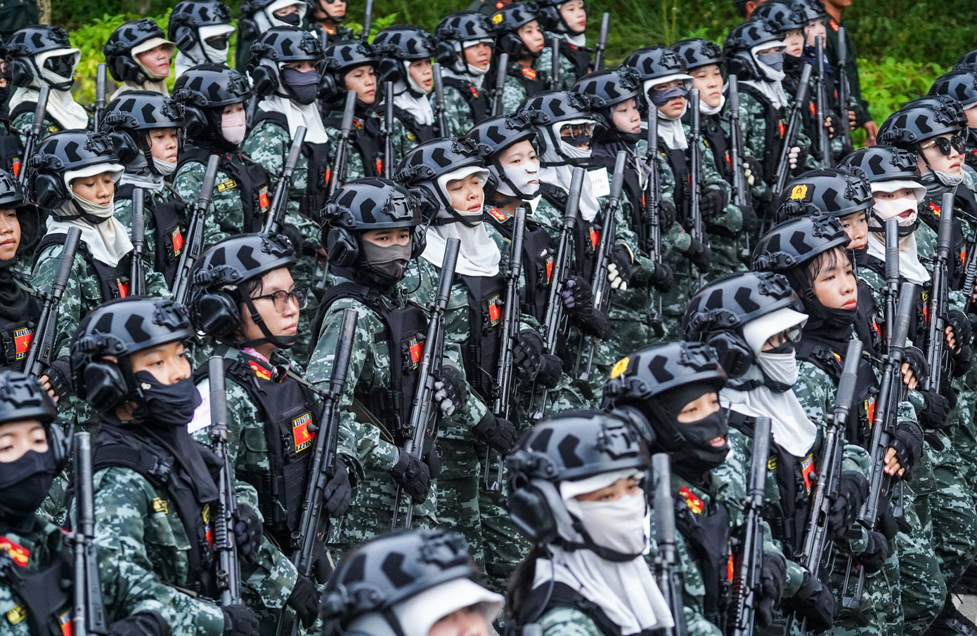 Khối nữ chiến sĩ cảnh sát đặc nhiệm mặc quân phục ngụy trang kỹ thuật số màu xanh rêu, đội mũ bảo hiểm đen gắn bộ đàm, đeo áo giáp mềm và trang bị súng tiểu liên MP5. Khối nữ chiến sĩ cảnh sát đặc nhiệm mặc quân phục ngụy trang kỹ thuật số màu xanh rêu, đội mũ bảo hiểm đen gắn bộ đàm, đeo áo giáp mềm và trang bị súng tiểu liên MP5.