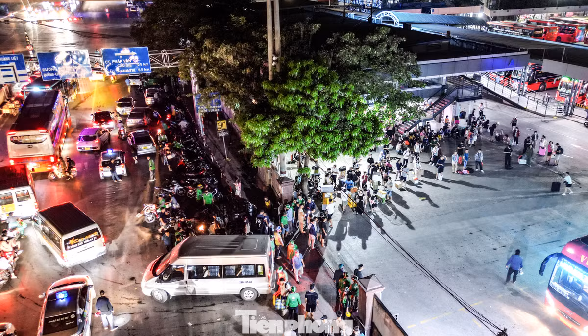 Tại bến xe Nước Ngầm thời điểm khoảng hơn 4 giờ sáng, hàng chục xe taxi, xe ôm công nghệ và truyền thống đỗ kín mặt đường Ngọc Hồi đoạn trước cổng bến xe để chờ đón khách.