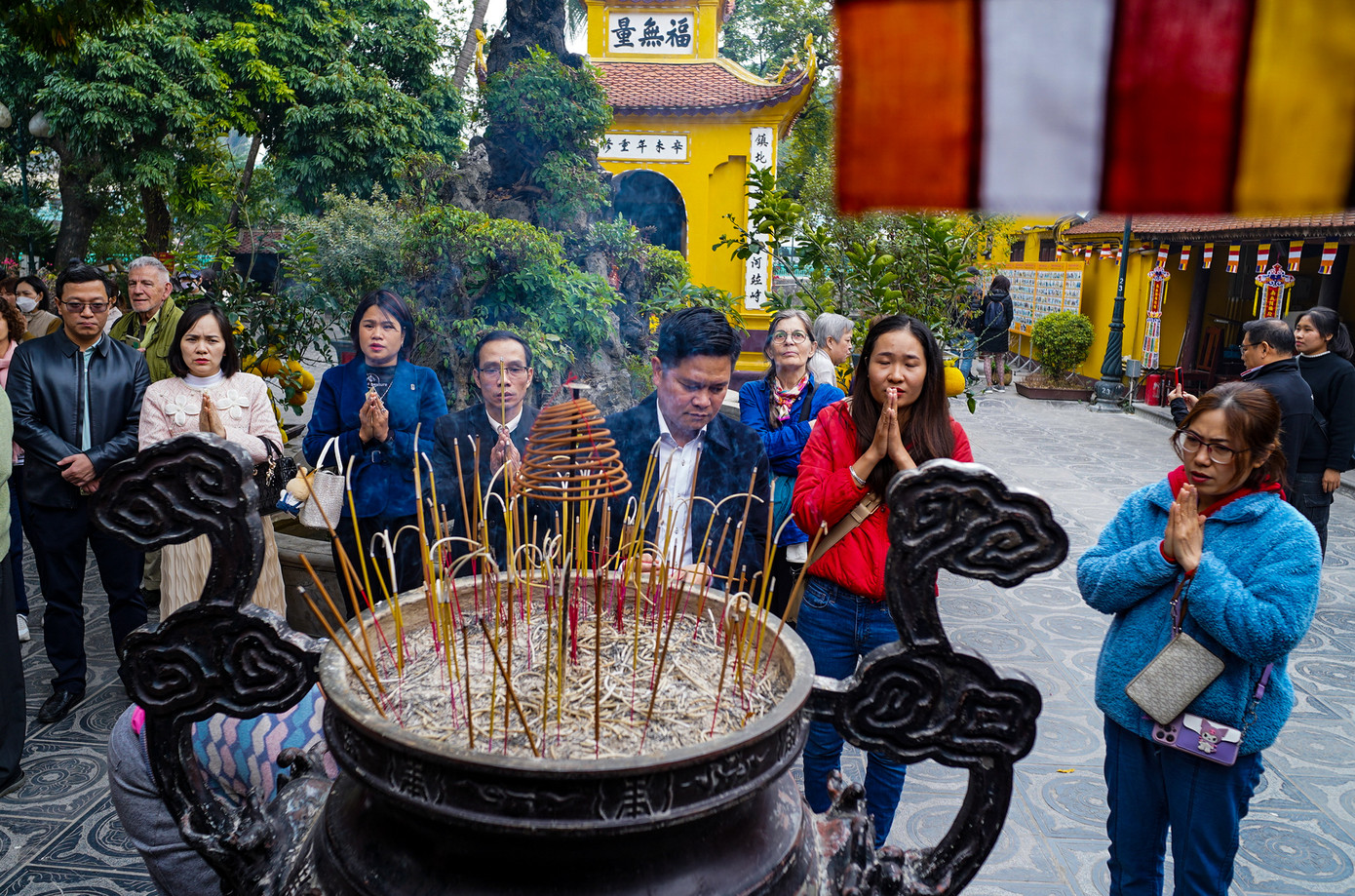 Người dân và du khách đến thắp hương tại chùa Trấn Quốc (quận Tây Hồ), khấn nguyện những điều tốt đẹp sẽ đến trong năm mới.