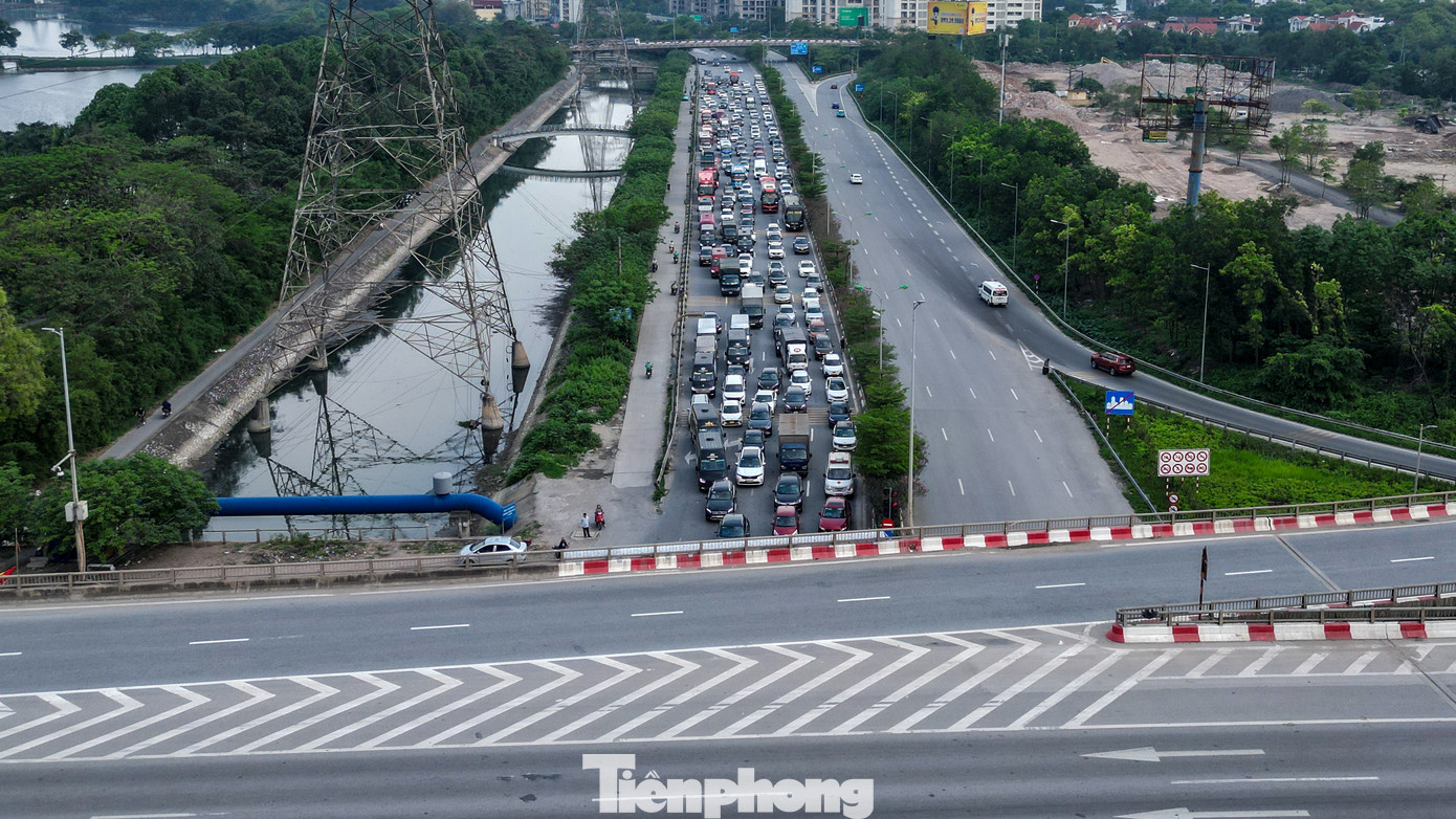 Dự báo, chiều và tối nay, lưu lượng phương tiện lưu thông trên các tuyến như Giải Phóng, Ngọc Hồi, đường Vành đai 3 trên cao, nút Pháp Vân - Cầu Giẽ - Ngọc Hồi bắt đầu tăng cao và tiếp tục dồn về nội đô. Trong ảnh: Ô tô xếp hàng ngang chờ qua đèn tín hiệu giao thông tại nút giao cao tốc Pháp Vân - Cầu Giẽ; trong khi đó chiều ngược lại khá vắng vẻ.