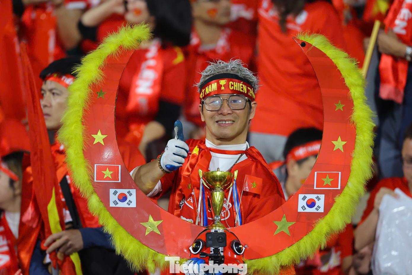 Cổ động viên trang trí, mặc màu đỏ khắp các khán đài.