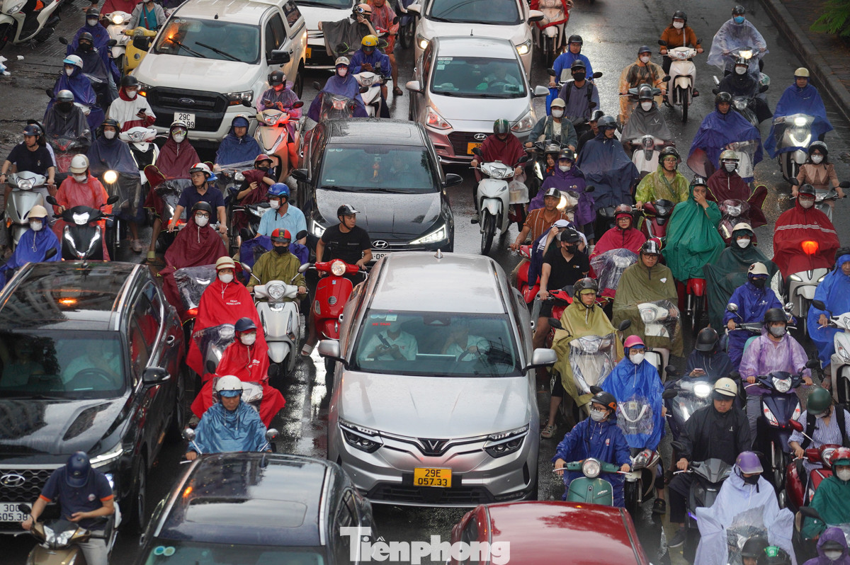 Xe máy và ôtô chen nhau trên đường.