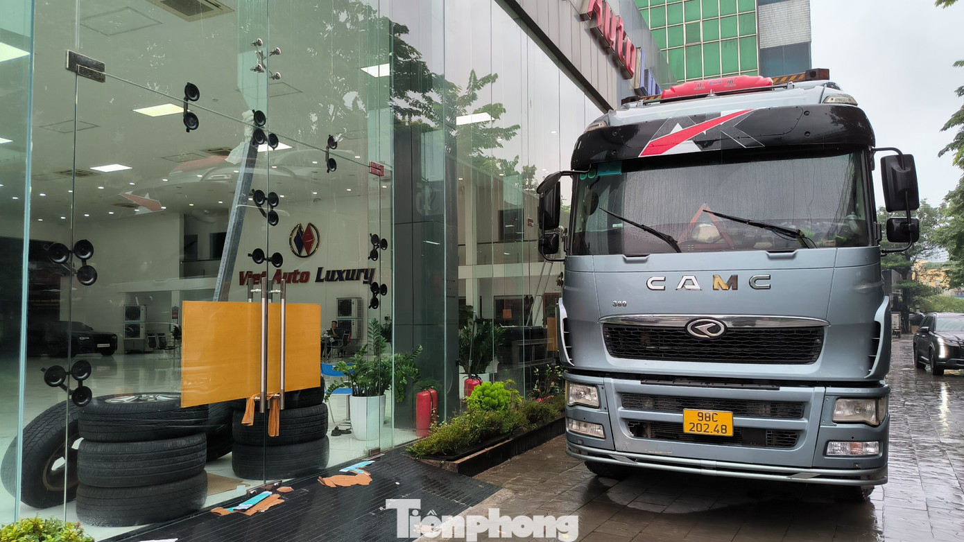 Cách đó không xa, một cửa hàng ở Hà Nội dùng xe container chặn trước cửa để chống bão số 3 Yagi.