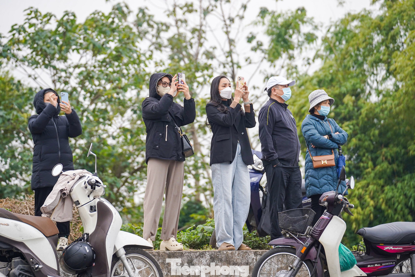 Trên tuyến đường đê Long Biên, đối diện đường băng sân bay Gia Lâm, rất đông người dân cùng phương tiện dừng lại theo dõi màn trình diễn của các biên đội bay.