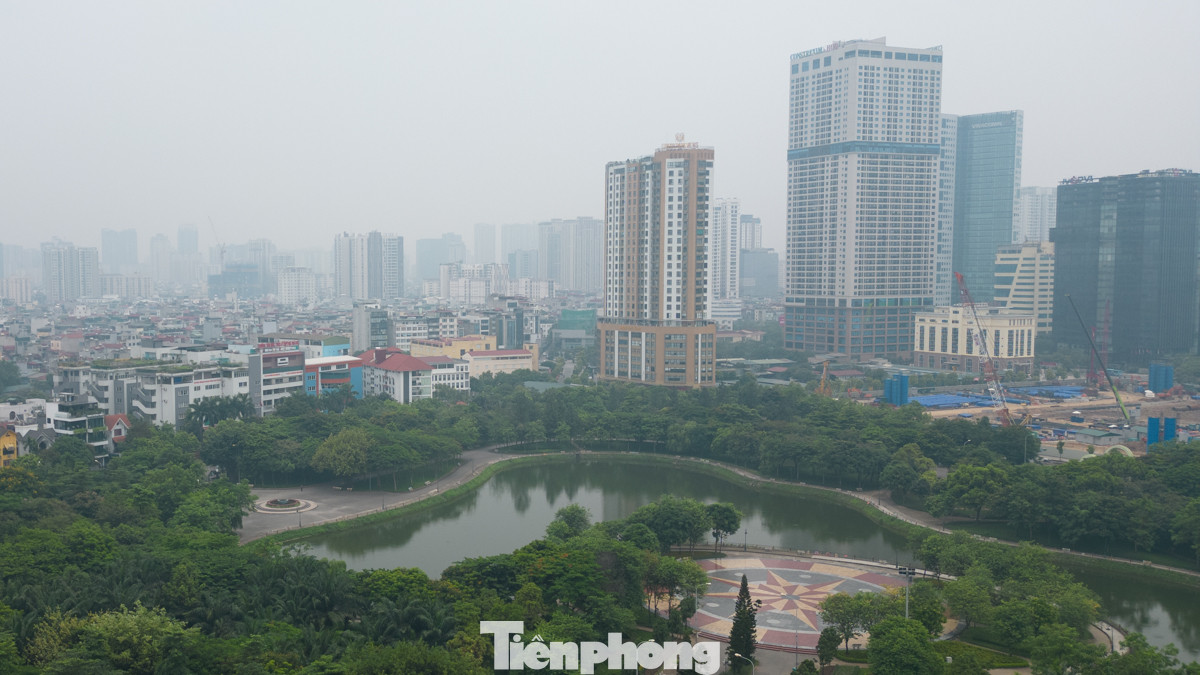 Tại công viên Cầu Giấy, các toà nhà phía xa ẩn hiện trong lớp không khí đục ngầu.