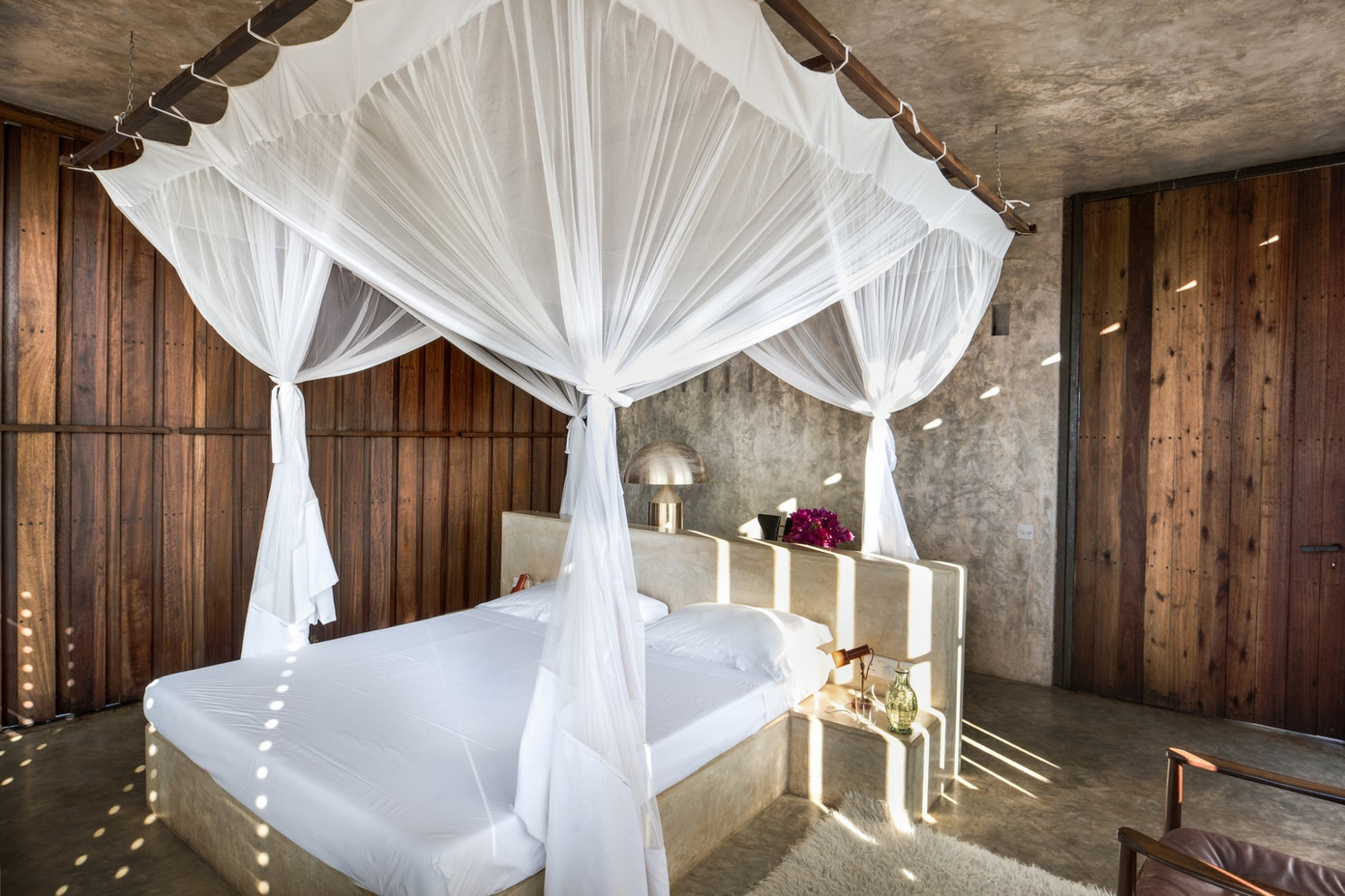 Khối bê tông hoạt động như một bánh đà nhiệt, giúp điều chỉnh vi khí hậu trong phòng, với các thanh gỗ có thể điều chỉnh được trên các bức tường phía Đông và phía Tây.