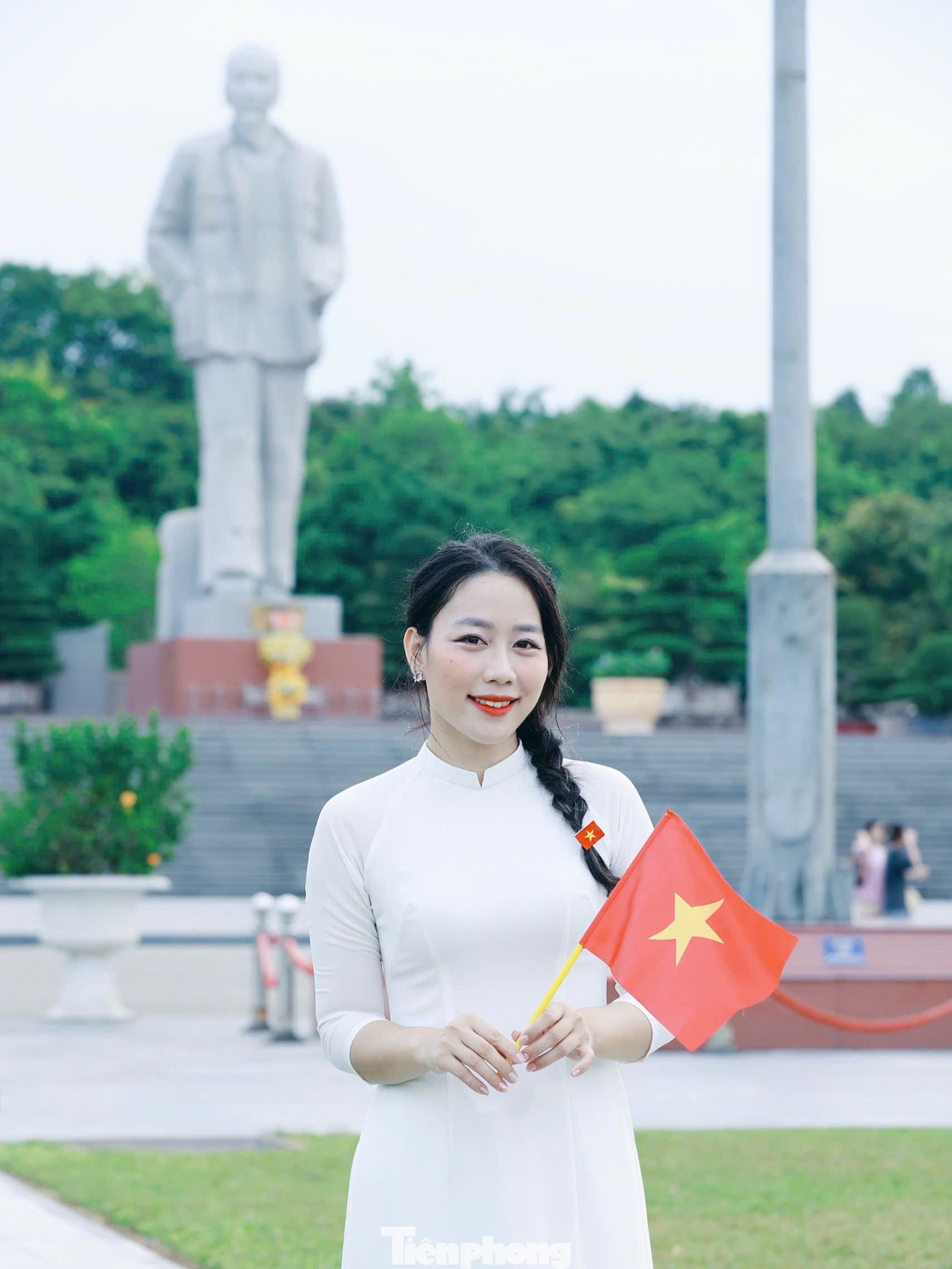 Các bạn trẻ trong tà áo dài nền nã, tay cầm lá cờ Tổ quốc, cùng nhau lưu giữ khoảnh khắc kỷ niệm.