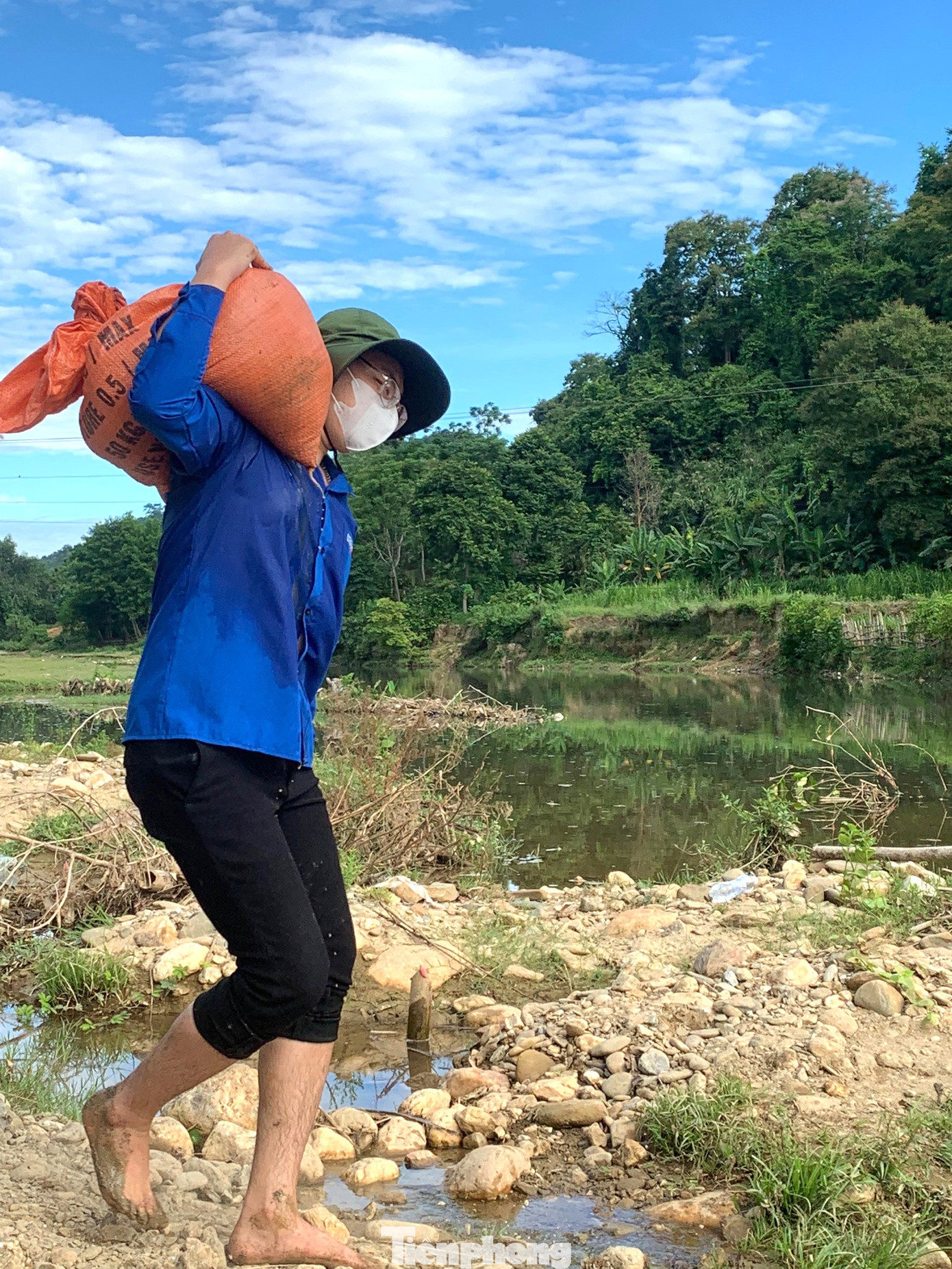 Có những bạn chân trần vận chuyển các bao cát đến vị trí vá đập