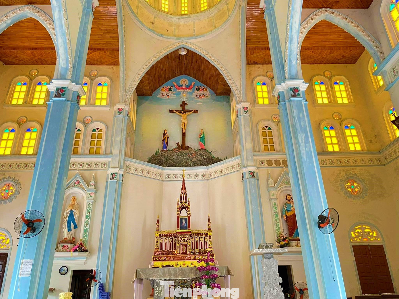 Bên trong nhà thờ có những mái vòm uốn cong, khung cửa sổ màu vàng cổ kính.