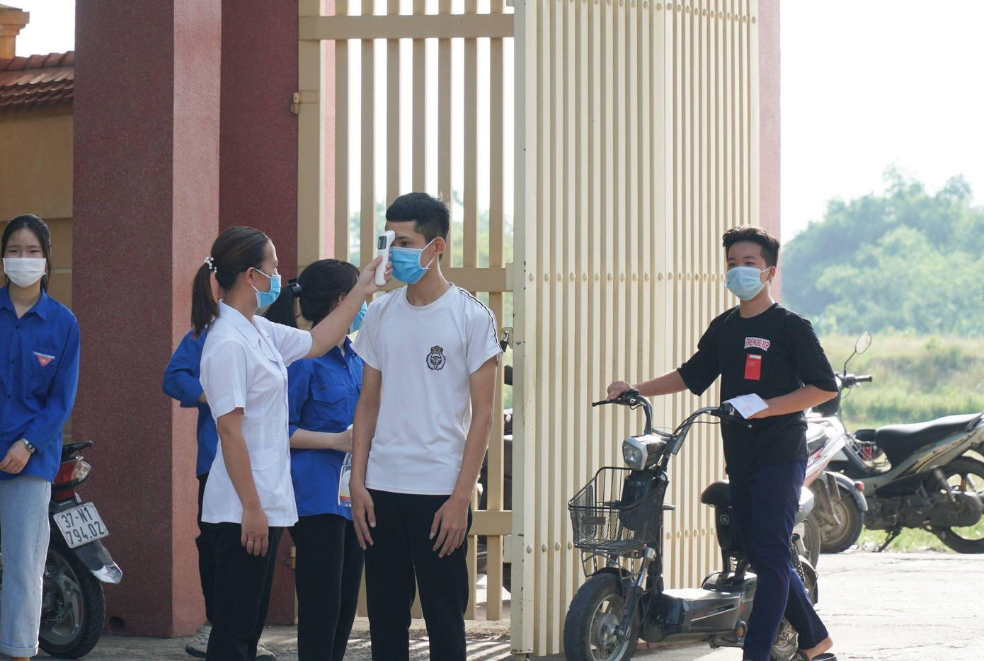 Thí sinh mang khẩu trang, đo thân nhiệt, rửa tay sát khuẩn trước khi vào điểm thi Thí sinh mang khẩu trang, đo thân nhiệt, rửa tay sát khuẩn trước khi vào điểm thi