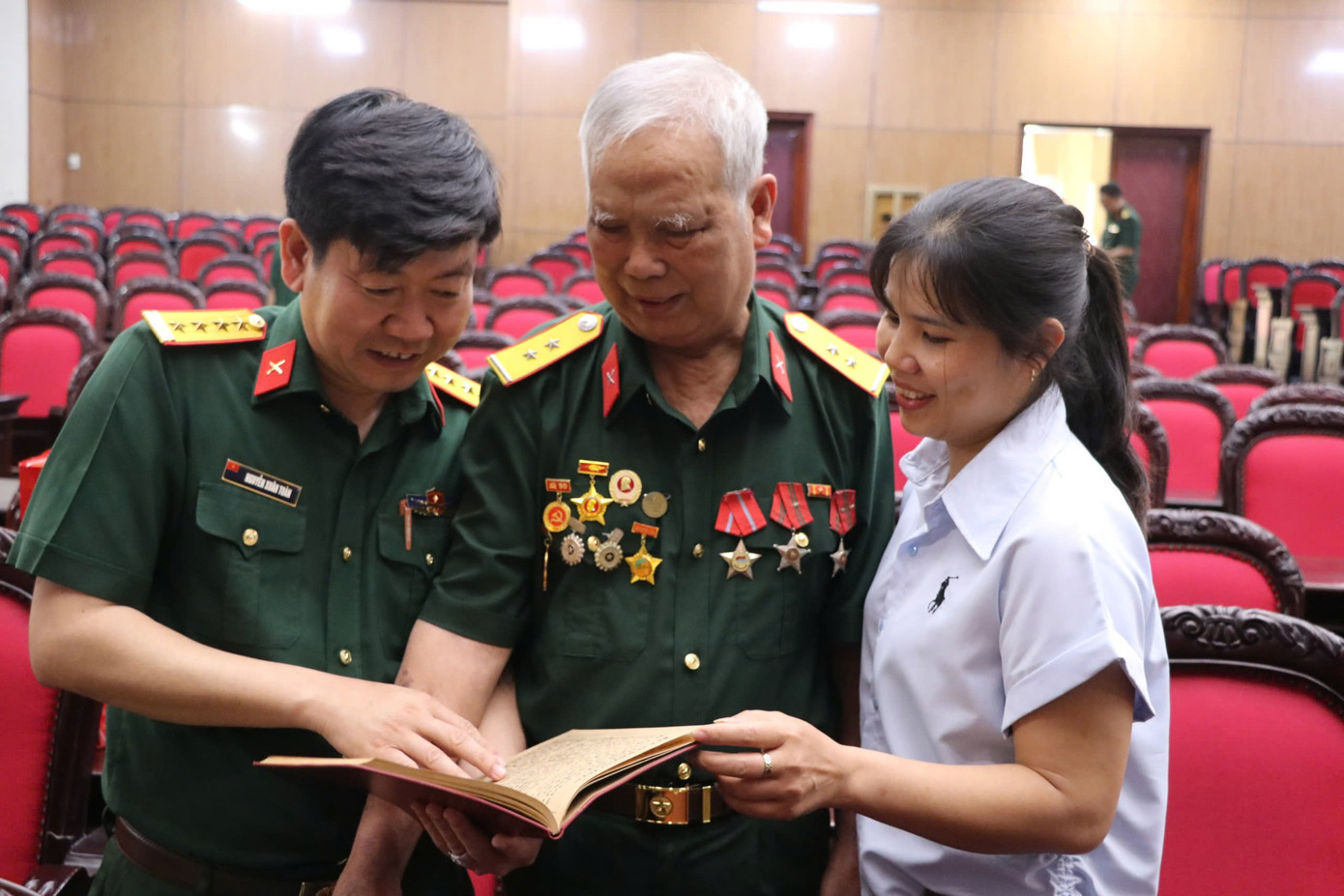 Cựu chiến binh Lê Đức Thuận xem lại cuốn sổ ghi chép ngay khi tiếp nhận