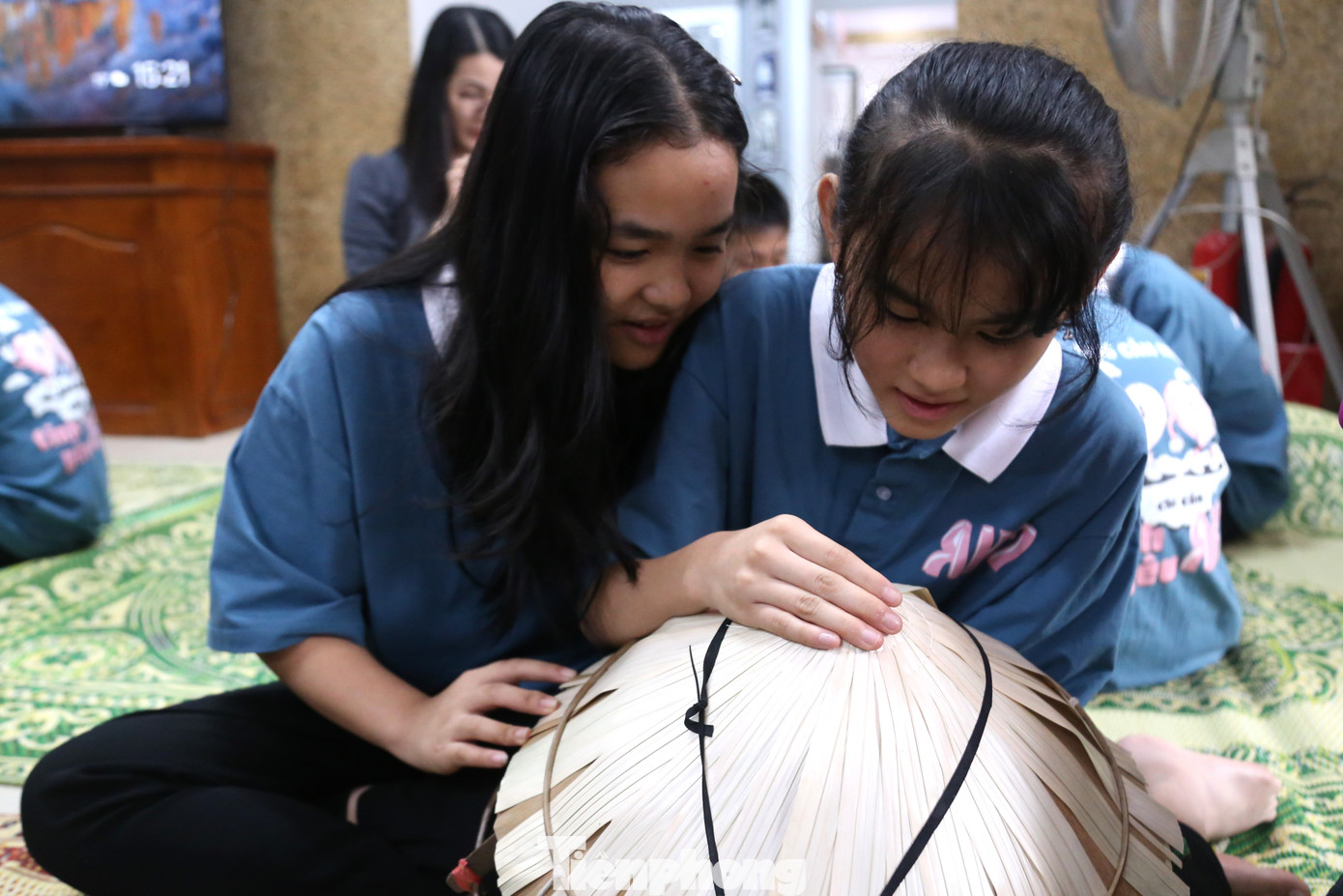 Các em say sưa chằm nón.