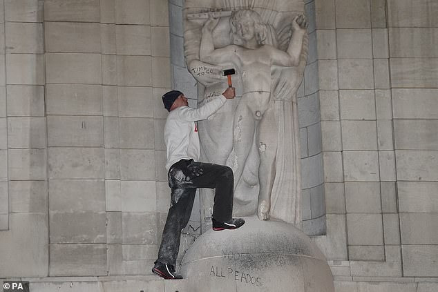 Người đàn ông dùng búa phá hủy tượng khỏa thân trước trụ sở BBC. Ảnh: PA.