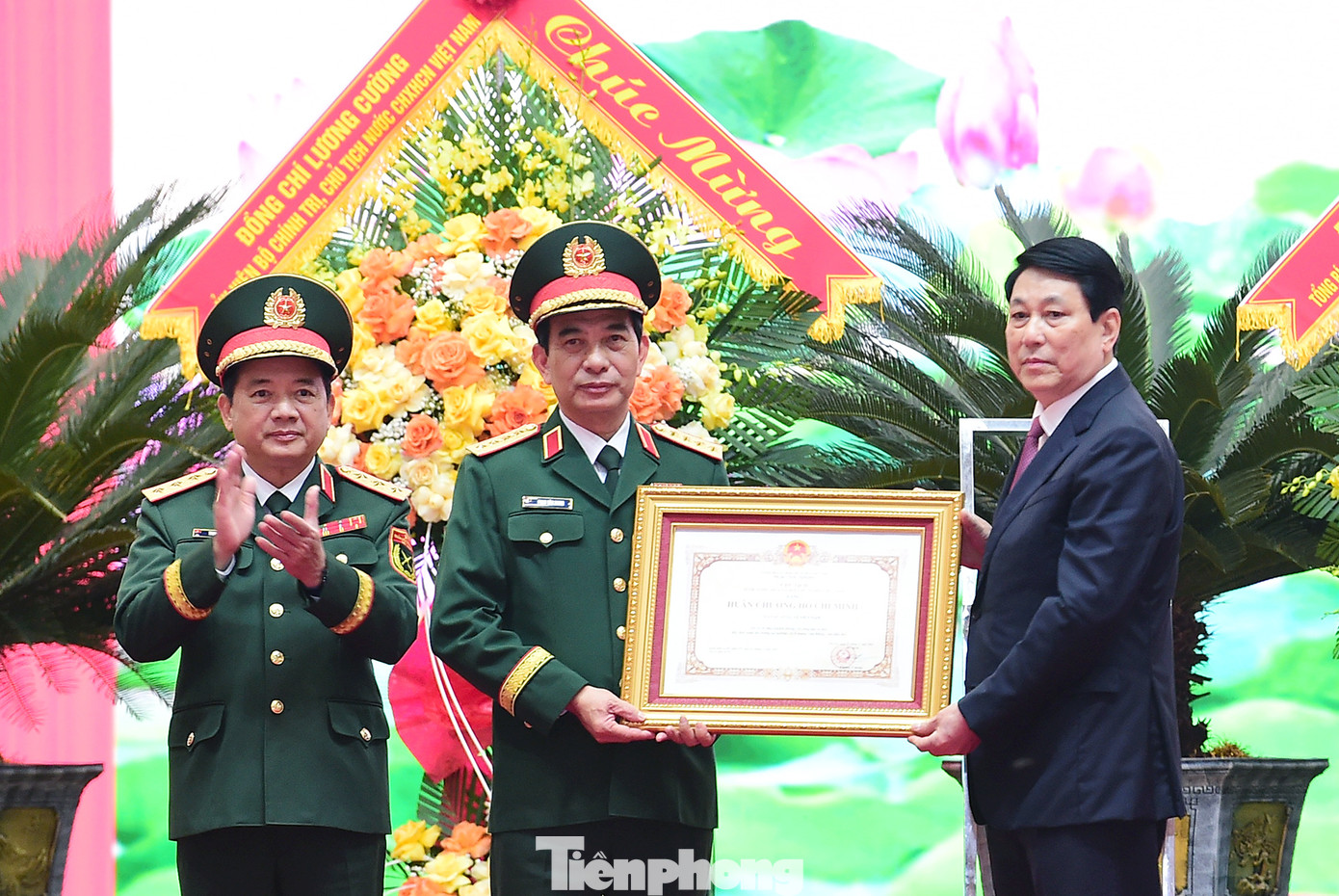 Chủ tịch nước Lương Cường gắn Huân chương Hồ Chí Minh lên cờ truyền thống của Dân quân tự vệ Việt Nam tại Lễ kỷ niệm 90 năm Ngày truyền thống Dân quân tự vệ. Ảnh: Xuân Tùng