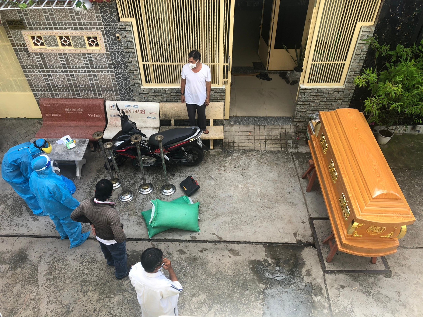 Nhân viên y tế đang lo mai táng cho bà Lưu Thị Thương (63 tuổi) sau khi qua đời vì COVID-19. Ảnh: Vân Sơn