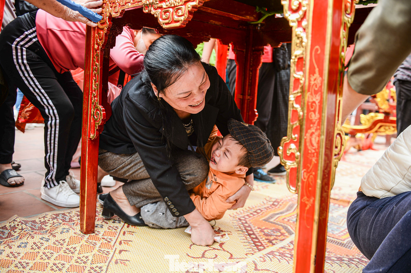 Nhiều người dân, du khách tranh thủ chui qua các kiệu để cầu may.