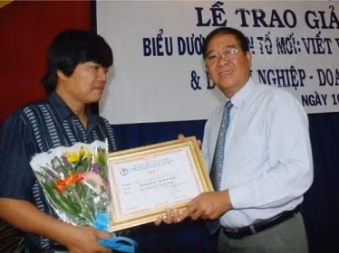 Nhà báo Hoàng Hùng (trái) trong lần nhận giải báo chí năm 2010. Nguồn: Người lao động