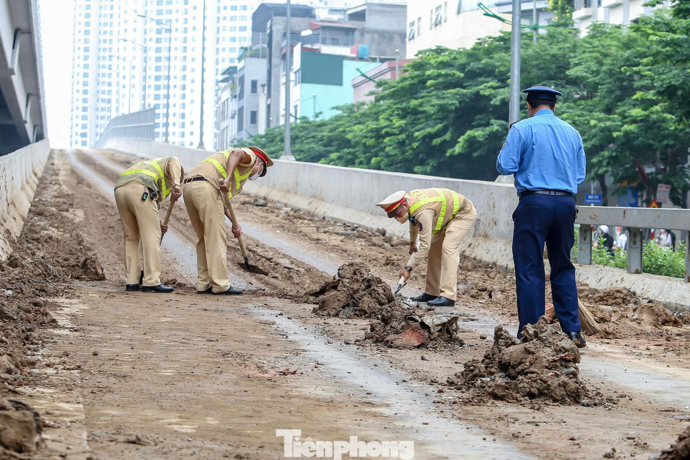 Lực lượng CSGT và Thanh tra giao thông có mặt để thu gọn đống bùn đất. Lực lượng CSGT và Thanh tra giao thông có mặt để thu gọn đống bùn đất.