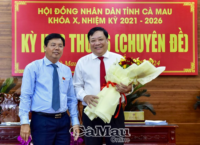 Bí thư Tỉnh uỷ, Chủ tịch HĐND tỉnh Cà Mau Nguyễn Tiến Hải (trái) tặng hoa chúc mừng tân Chủ tịch UBND tỉnh Phạm Thành Ngại - Ảnh: Cà Mau Online.