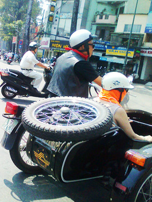 Cặp vợ chồng đi chơi phố trên sidecar độ