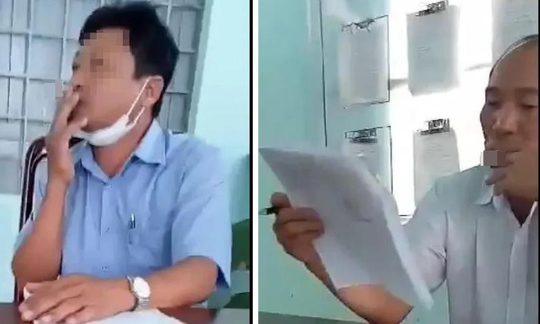 Ông Dương và ông Chiến (phải) bị tố hút thuốc khi đang tiếp dân trong giờ làm việc. Ảnh cắt từ clip