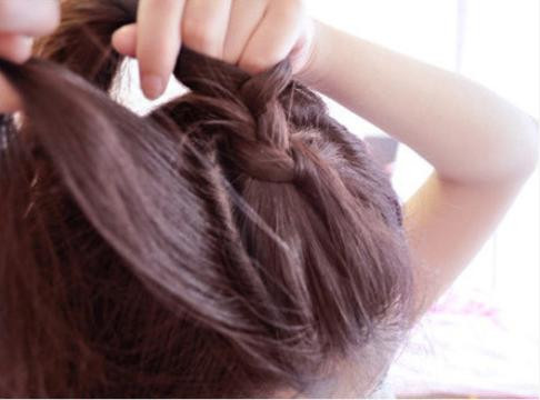 Rẽ phần lệch sang một bên Tết từ trước ra sau, đến đỉnh đầu thì tết ngang sang một bên và cố định lại Ở bên đối diện bạn cũng tết một lọn tóc từ trên đỉnh đầu xuống. Phần đuôi tóc bạn dùng máy uốn xoăn lên để tạo độ phồng cho tóc.