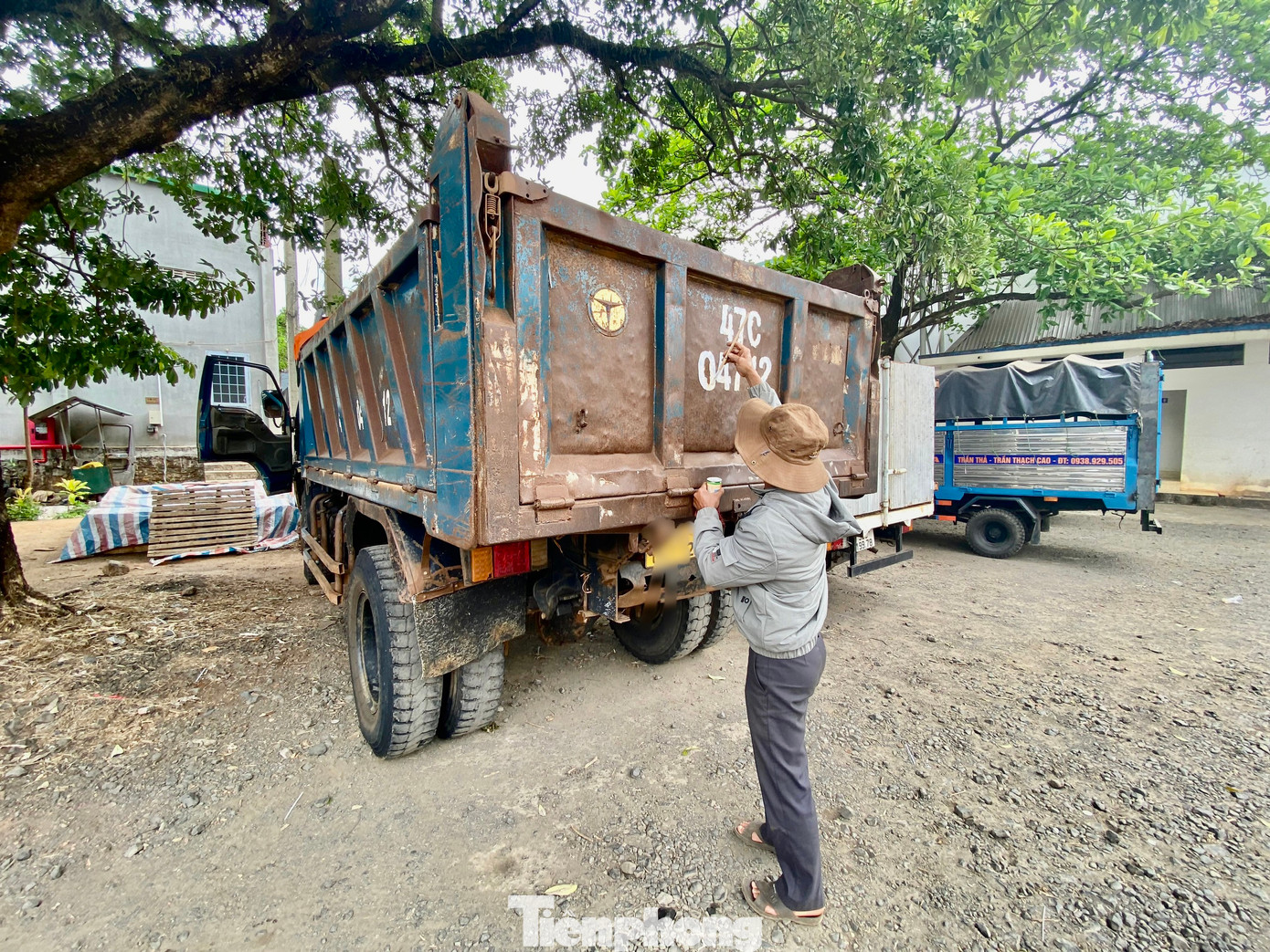 Lái xe đang sơn lại biển số cho rõ trước khi vào kiểm định.