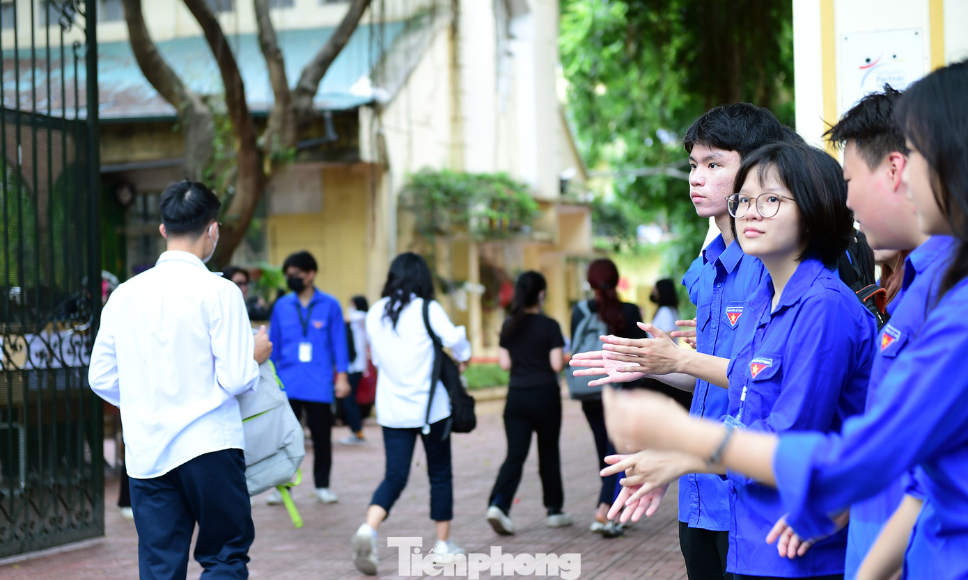 Các tình nguyện viên hỗ trợ, hướng dẫn thí sinh nơi gửi xe, gửi đồ, vị trí phòng thi; phát tặng nước uống miễn phí, cổ vũ tinh thần thí sinh tự tin bước vào phòng thi. Ảnh: Tường Kha
