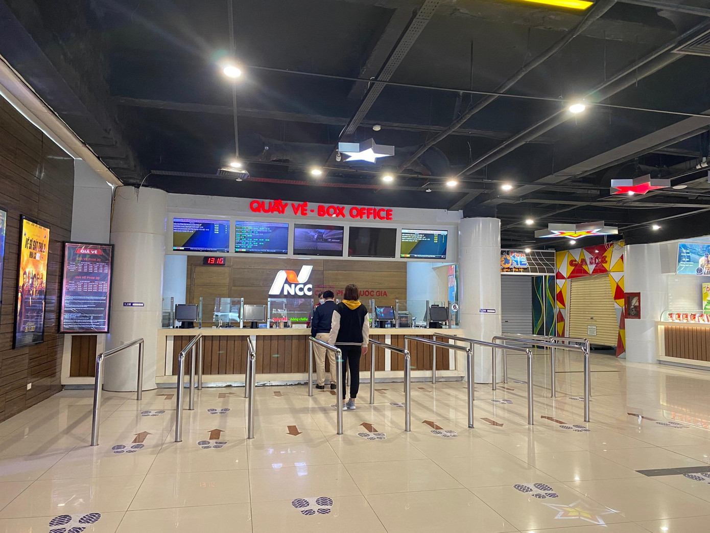 Quầy bán vé lác đác có người đứng xếp hàng mua vé xem phim.