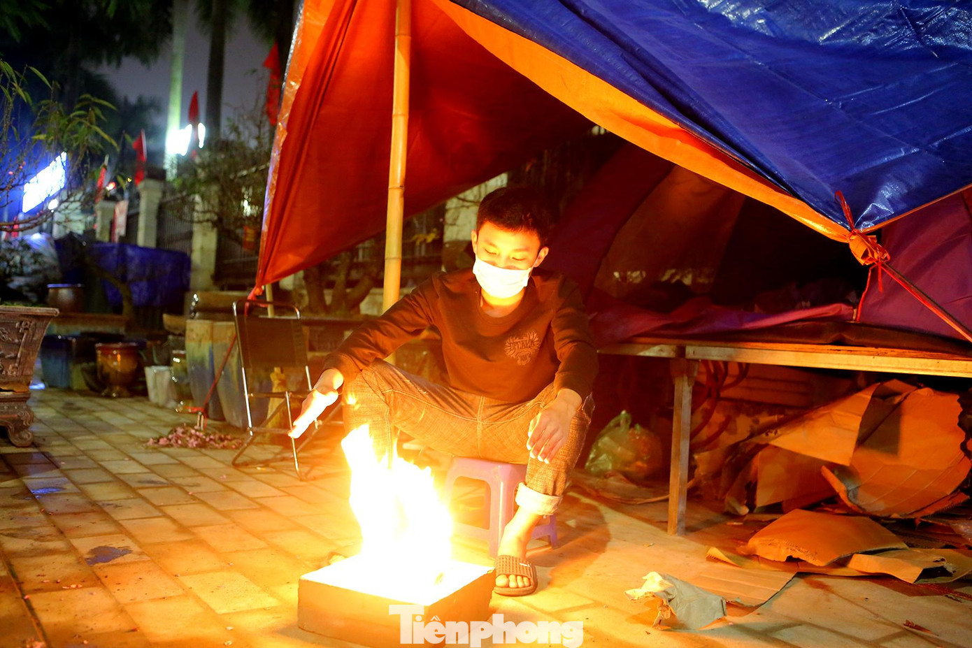 1 giờ sáng 21/1 - thời điểm chỉ còn cách Tết Nguyên Đán Nhâm Dần 2022 khoảng chục ngày nữa, một số tiểu thương phải đốt lửa sưởi ấm trên phố Lạc Long Quân vừa để chống chọi với sương lạnh cùng mưa phùn rả rích vừa lên dây cót tinh thần để chuẩn bị thức đêm trông coi cây cảnh. 1 giờ sáng 21/1 - thời điểm chỉ còn cách Tết Nguyên Đán Nhâm Dần 2022 khoảng chục ngày nữa, một số tiểu thương phải đốt lửa sưởi ấm trên phố Lạc Long Quân vừa để chống chọi với sương lạnh cùng mưa phùn rả rích vừa lên dây cót tinh thần để chuẩn bị thức đêm trông coi cây cảnh.