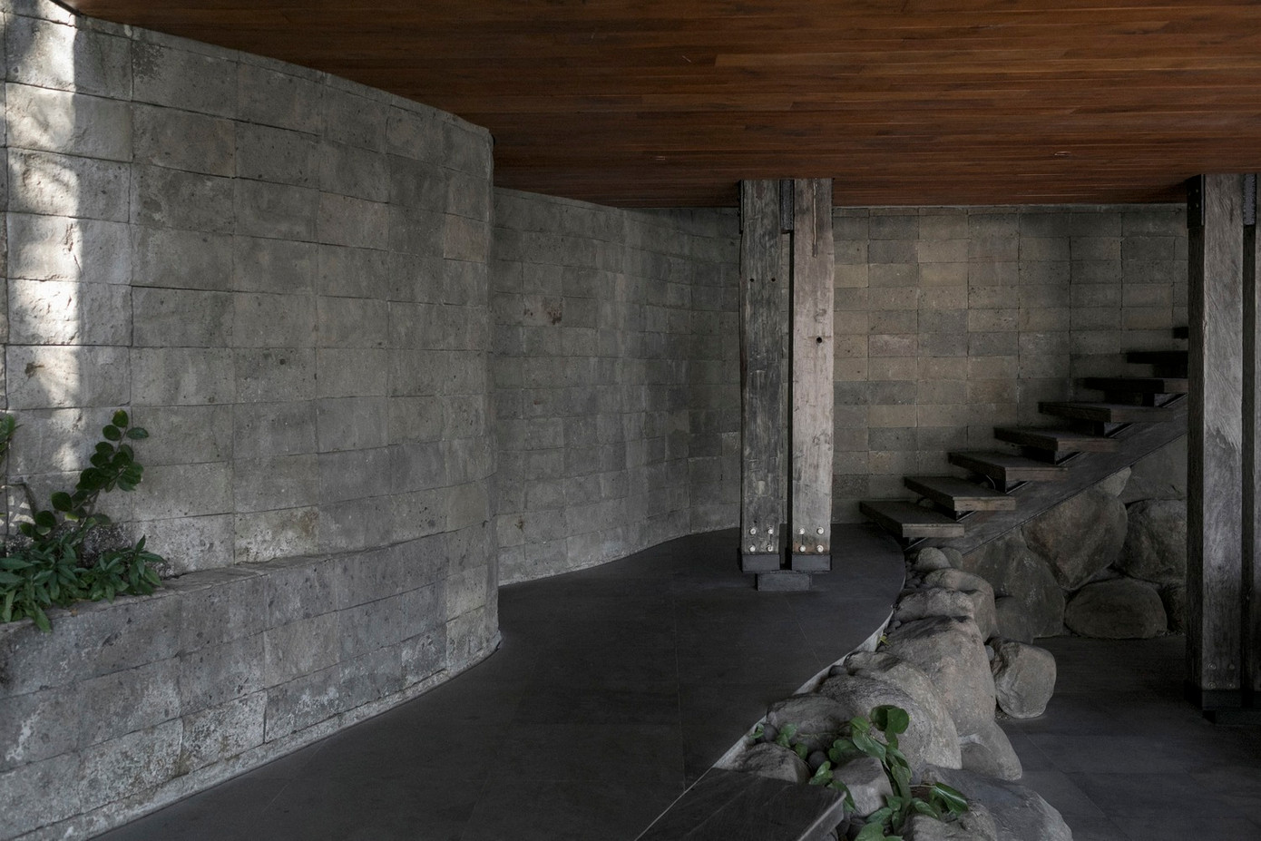 Các cột neo giữ cấu trúc thứ cấp của ngôi nhà, gồm dầm thép và dầm gỗ ulin để đỡ mái nhà bằng ván lợp ulin với phần nhô ra đúc hẫng lớn. Các cột neo giữ cấu trúc thứ cấp của ngôi nhà, gồm dầm thép và dầm gỗ ulin để đỡ mái nhà bằng ván lợp ulin với phần nhô ra đúc hẫng lớn.