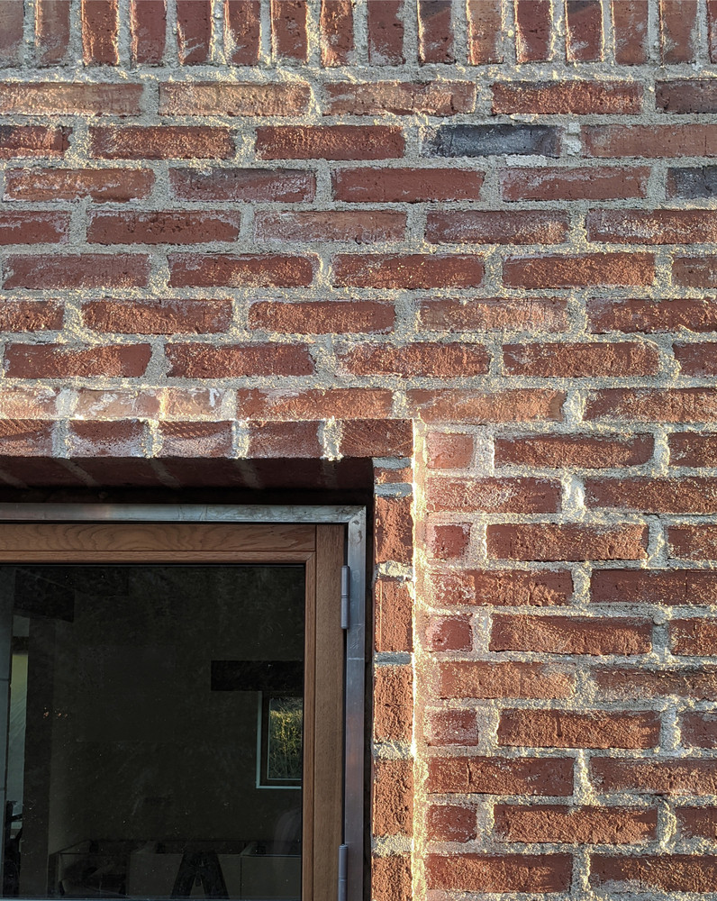 Để tiết kiệm chi phí xây dựng, nhóm thiết kế không sơn trát mà sử dụng chính phần gạch thô để tạo nên mặt tiền độc đáo cho ngôi nhà.