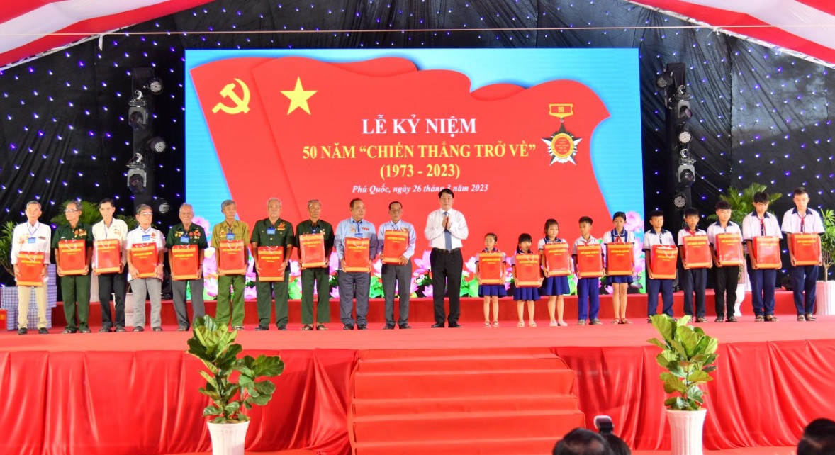 Đại tướng Lương Cường trao quà cho các cựu tù và học sinh có hoàn cảnh khó khăn. Ảnh: P. Vũ.