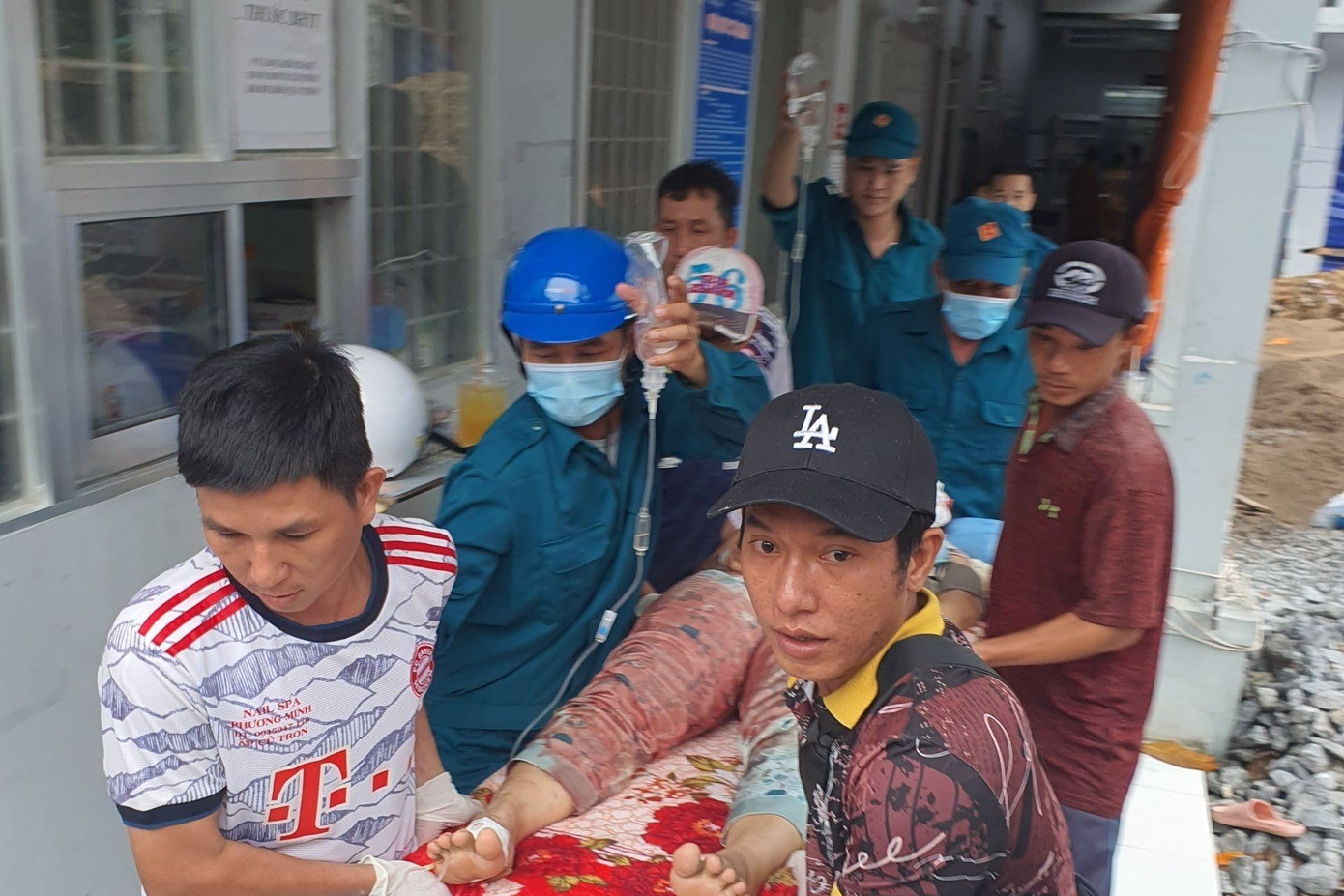 Người dân và lực lượng dân quân hỗ trợ đưa người dân đi cấp cứu.