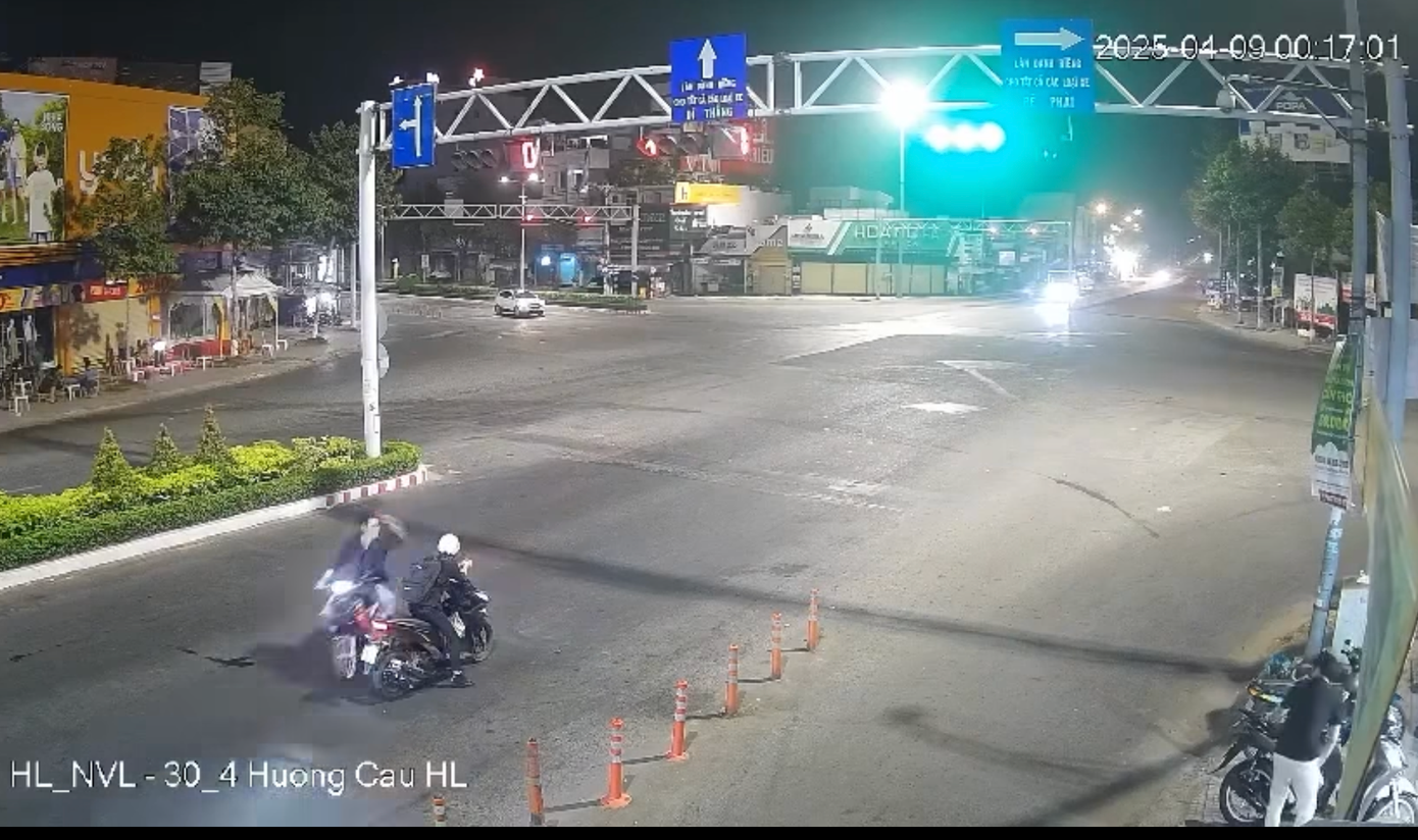 Hình ảnh đối tượng lạ mặt (bên trái) áp sát, dùng vật nhọn đâm vào lưng người đi đường (Ảnh cắt từ clip).