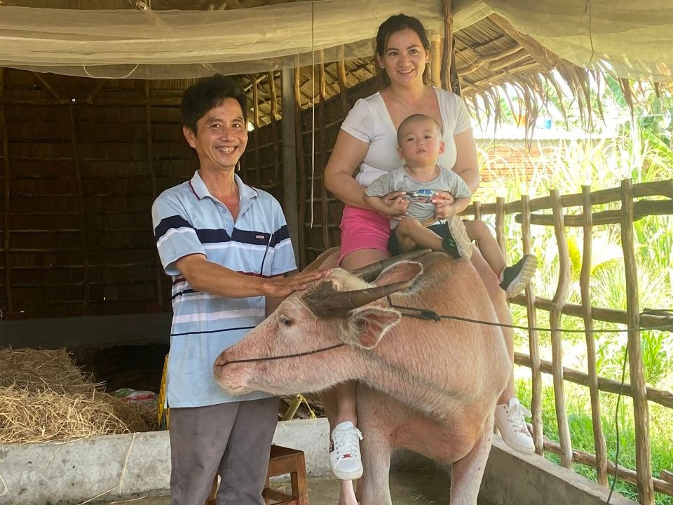 Du khách thích thú leo lên lưng trâu chụp ảnh kỷ niệm.