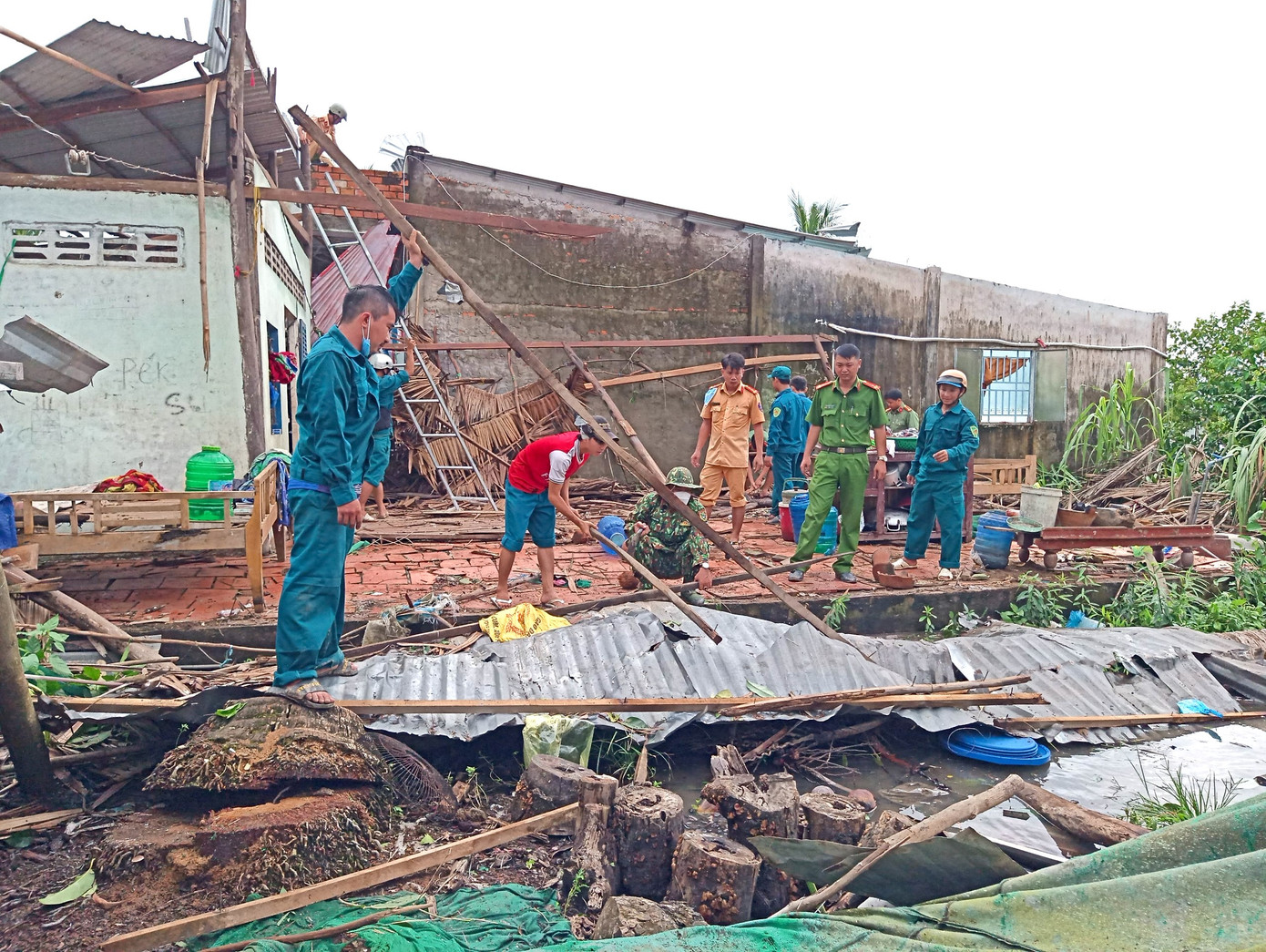Lực lượng địa phương giúp người dân dân dọn dẹp nhà cửa. Ảnh: Phương Vũ.