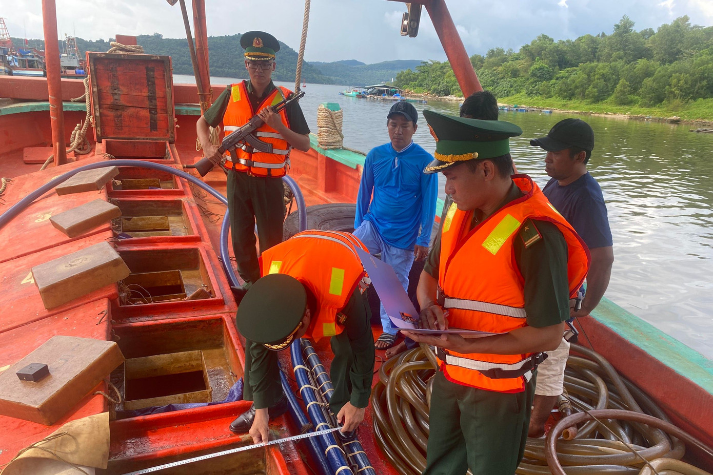 Cán bộ đồn Biên phòng cửa khẩu cảng An Thới đo khối lượng dầu trên 2 tàu vận chuyển trái phép. Ảnh: Tiến Vinh. Cán bộ đồn Biên phòng cửa khẩu cảng An Thới đo khối lượng dầu trên 2 tàu vận chuyển trái phép. Ảnh: Tiến Vinh.