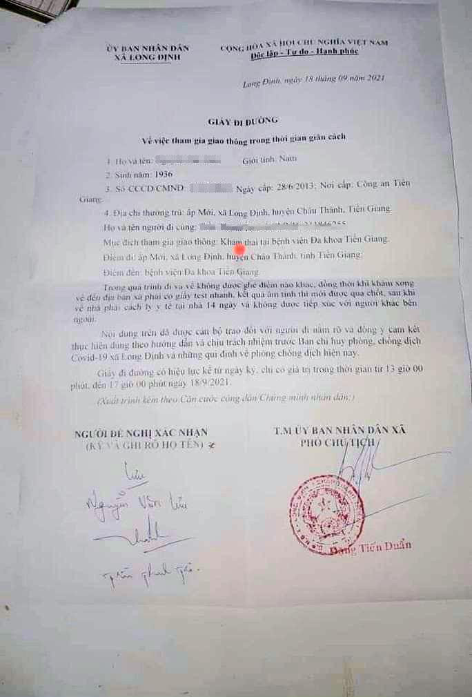 Giấy đi đường UBND xã Long Định cấp thể hiện nội dung cho hai người đàn ông đi khám thai.