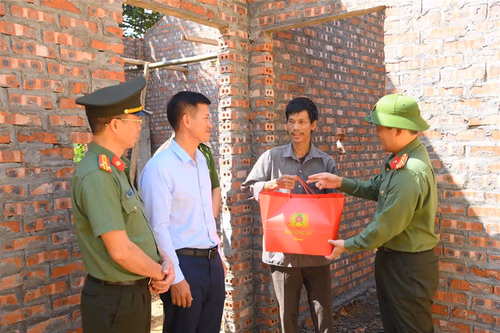 Đoàn công tác kiểm tra tiến độ xây dựng nhà cho người dân và tặng quà của Bộ Công an cho các hộ dân.
