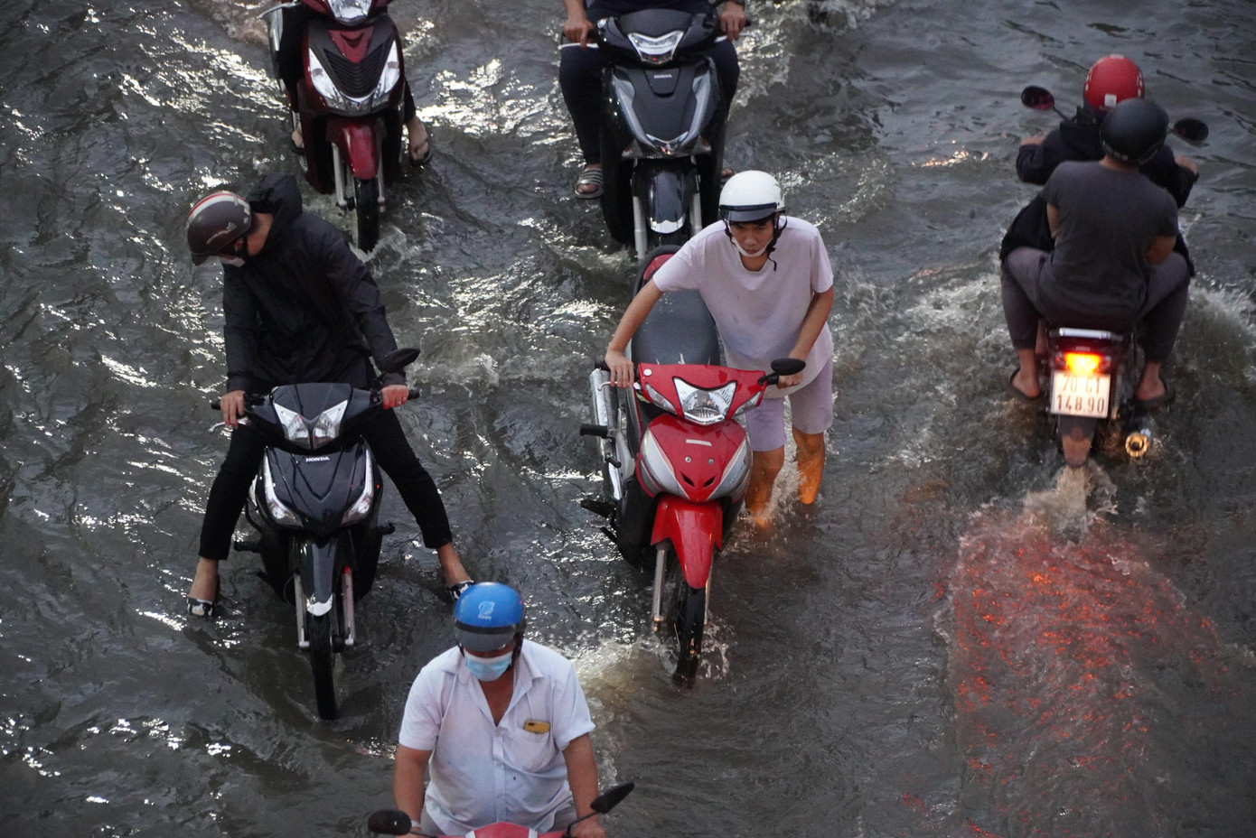 Nước ngập làm nhiều phương tiện bị chết máy, người dân phải bì bõm lội nước dẫn bộ.