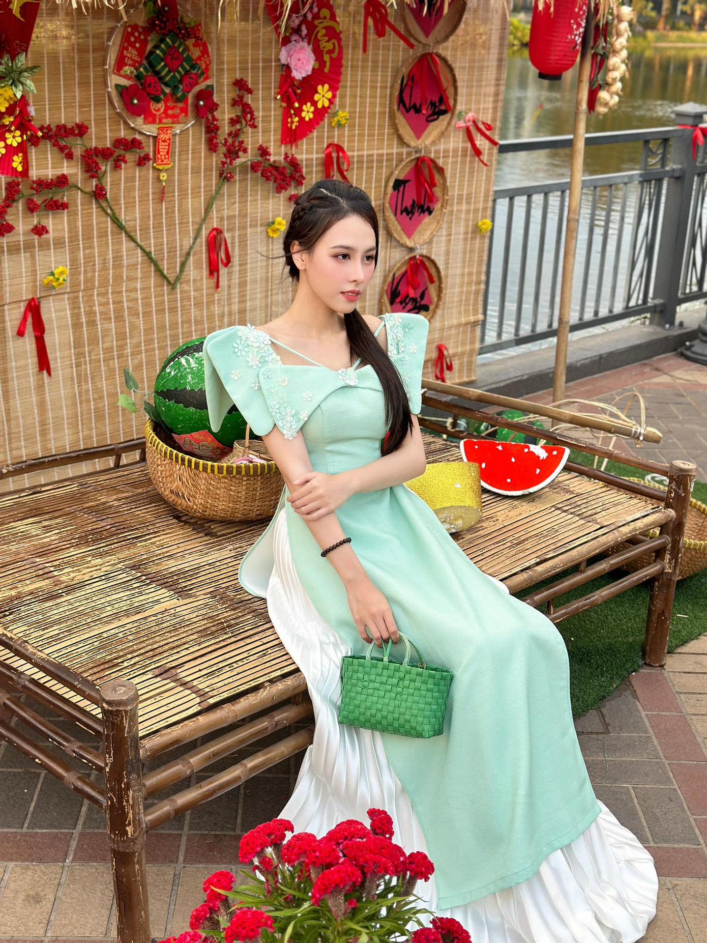 Á hậu Ngọc Hằng diện áo dài cách tân tông màu xanh pastel, phối cùng túi cói màu xanh độc đáo.