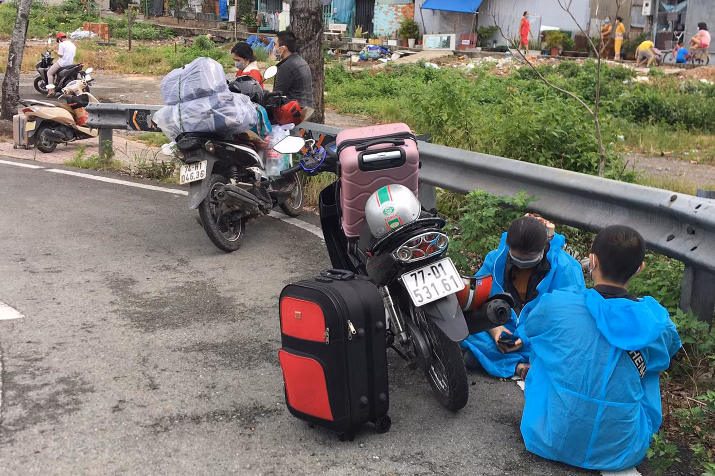 Không được lưu thông qua chốt kiểm soát, nhiều người tấp xe bên lề đường ngồi đợi vì không biết đi đâu.