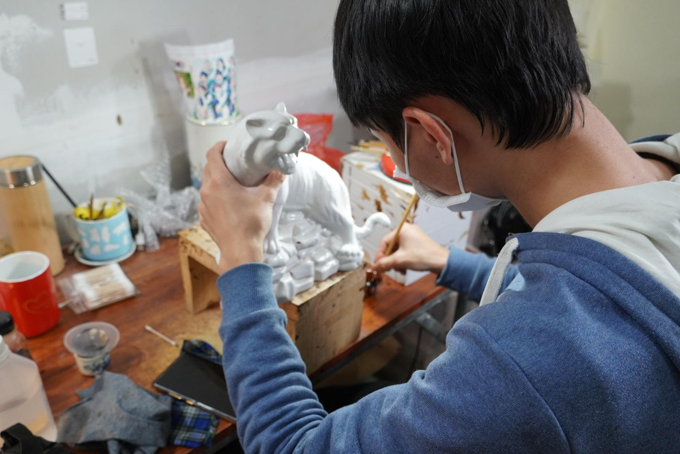 Anh Tuấn Anh (26 tuổi, thợ làm nghề 3 năm) chia sẻ:“Khi thao tác, người thợ chú ý nét vẽ bằng vàng phải căng, không bị nhòe thì khi nung xong, sản phẩm sẽ bóng và rõ đường vàng trên con hổ” Anh Tuấn Anh (26 tuổi, thợ làm nghề 3 năm) chia sẻ:“Khi thao tác, người thợ chú ý nét vẽ bằng vàng phải căng, không bị nhòe thì khi nung xong, sản phẩm sẽ bóng và rõ đường vàng trên con hổ”