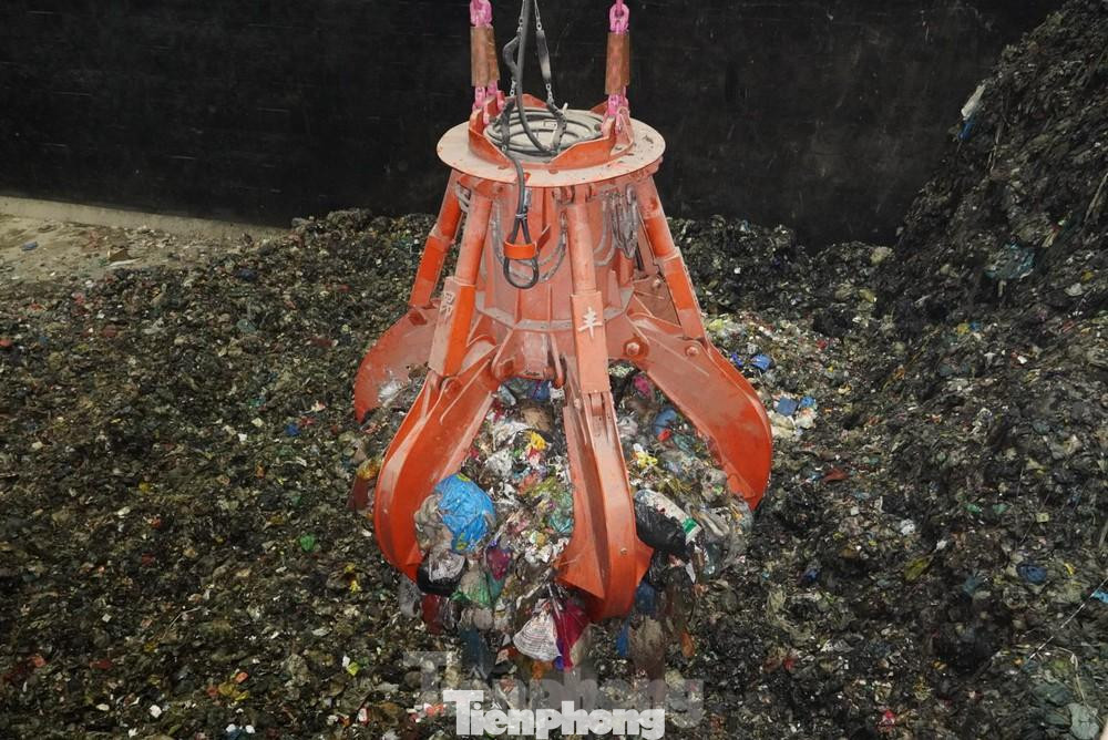 Cẩu trục ép và bốc rác từ bể chứa ra buồng đốt Cẩu trục ép và bốc rác từ bể chứa ra buồng đốt