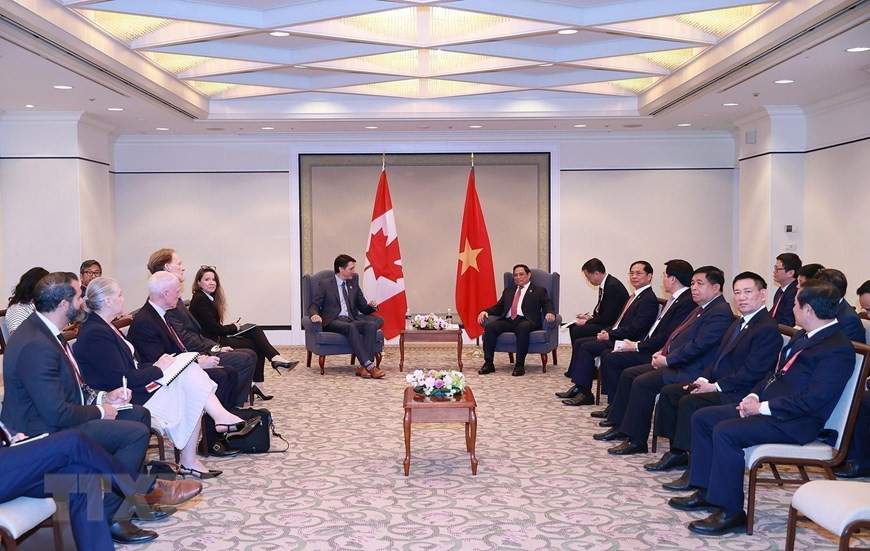 Thủ tướng Phạm Minh Chính gặp Thủ tướng Canada Justin Trudeau. (Ảnh: Dương Giang/TTXVN)