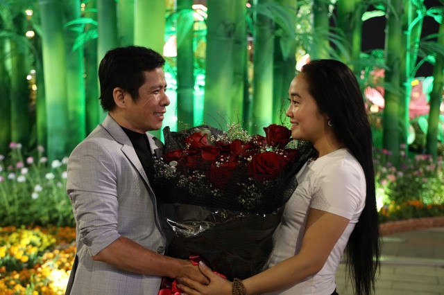 Một chàng trai trao bó hoa hồng cho người yêu.